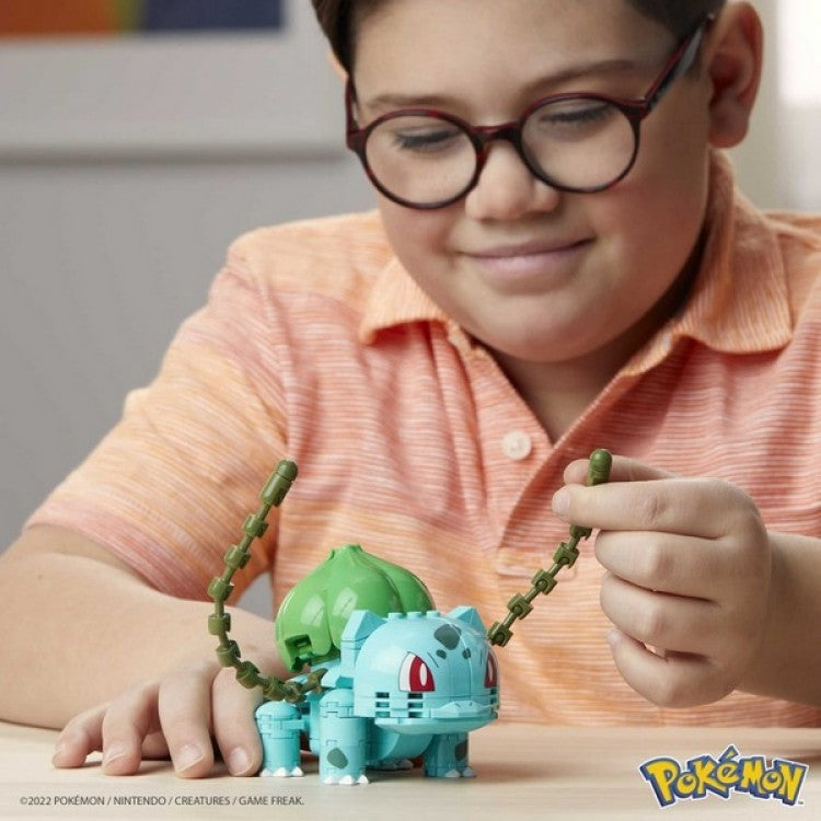 Enfant manipulant les lianes de la maquette Bulbizarre posée sur une table